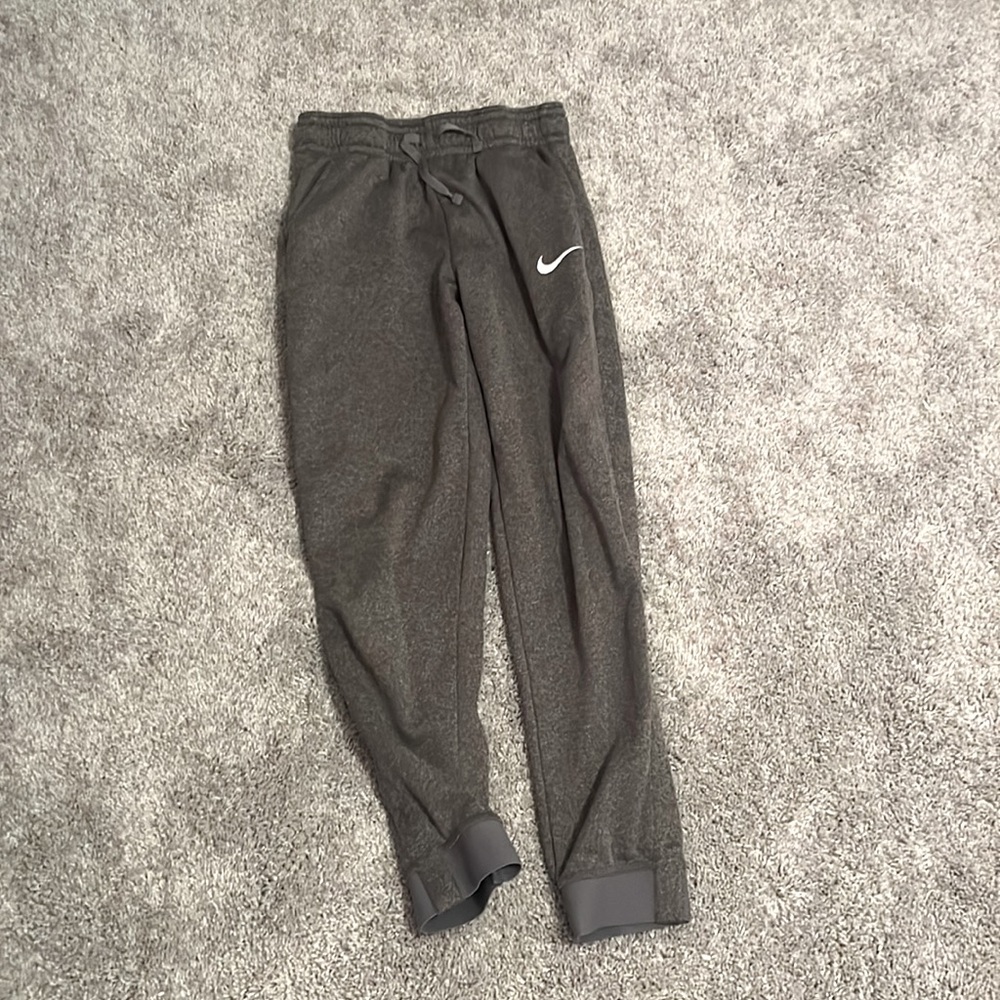 dark grey nike sweatpants.